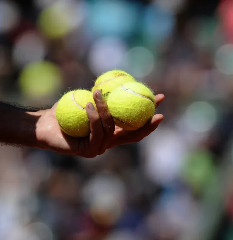 Tennis player holding tennis balls