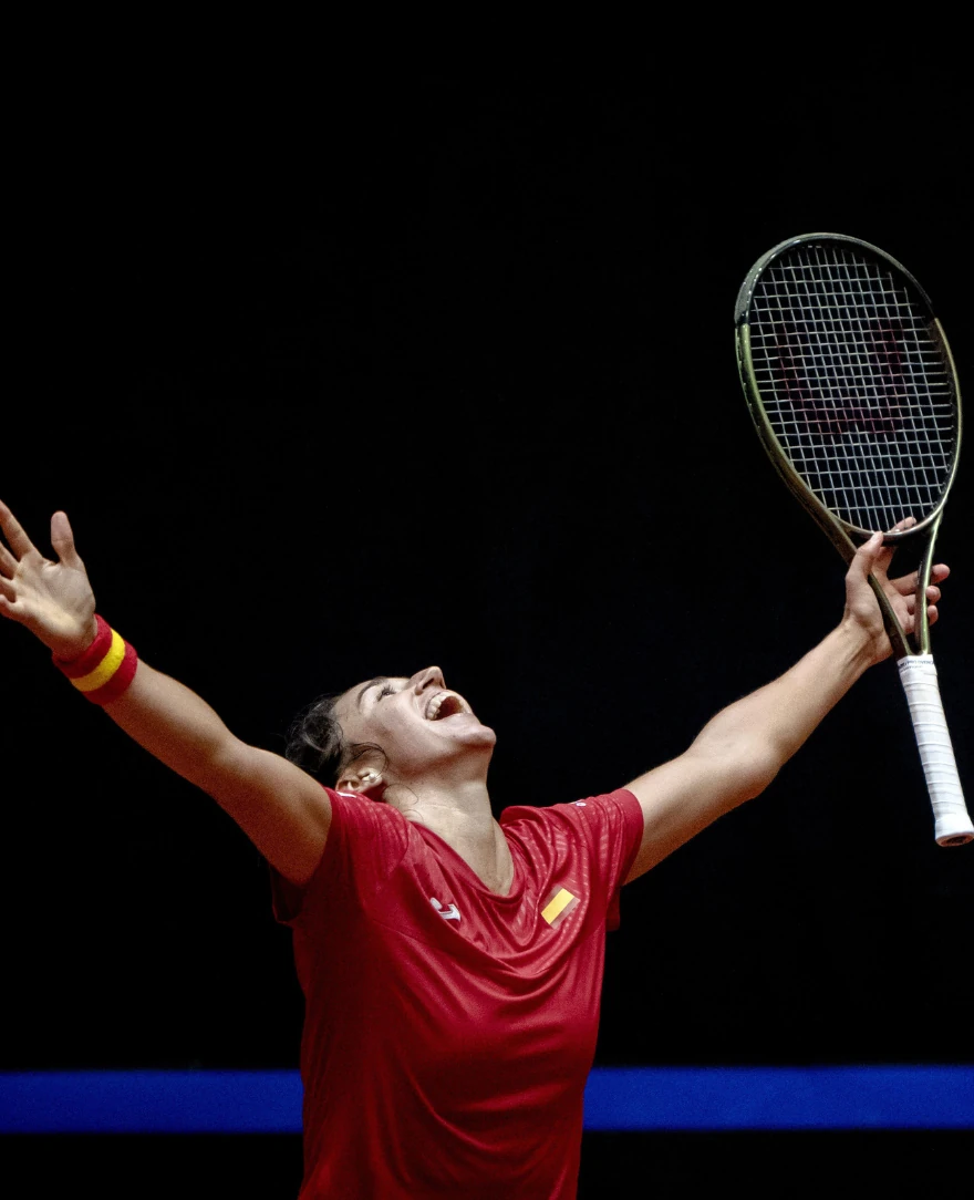 Female tennis player celebrating a victory.